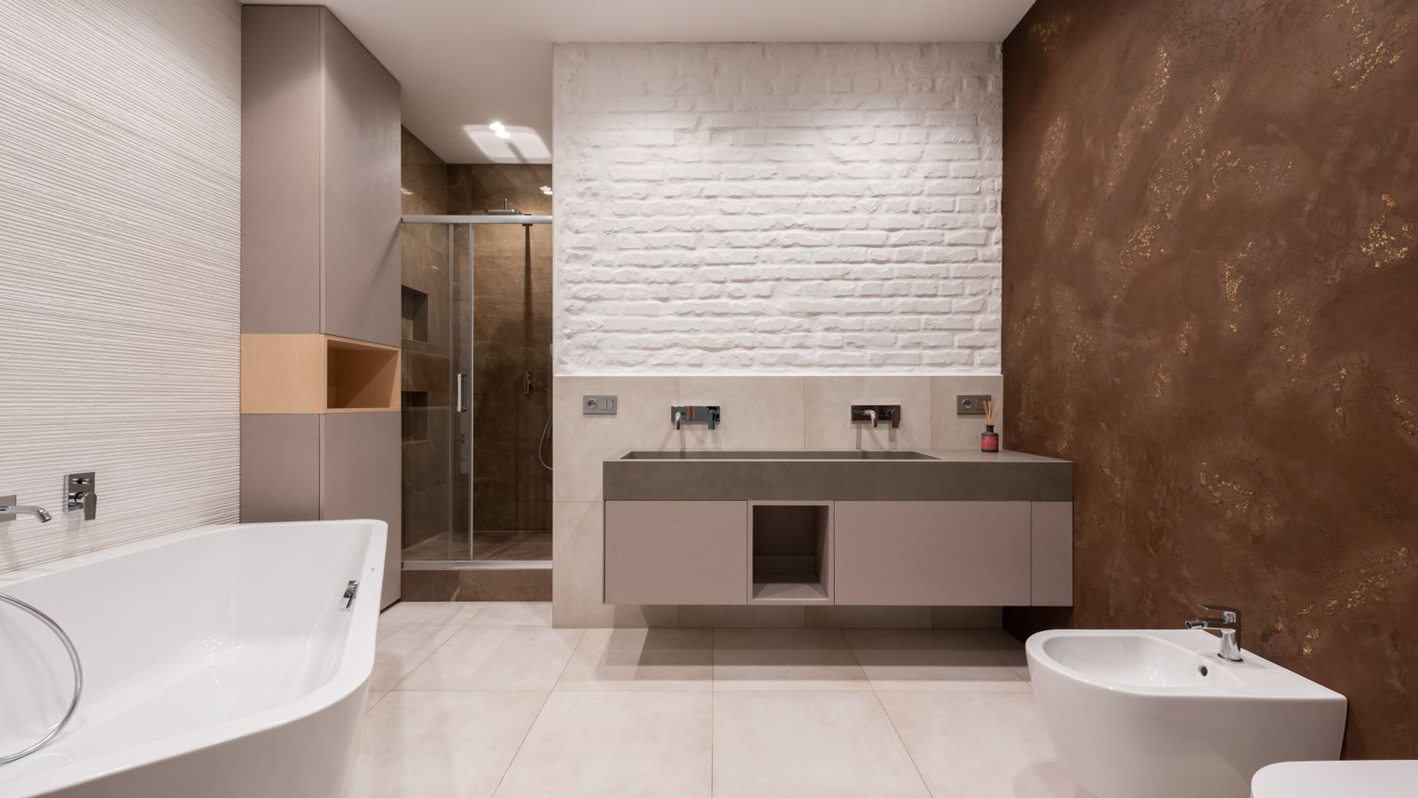 Modern bathroom with copper-toned wall and freestanding tub